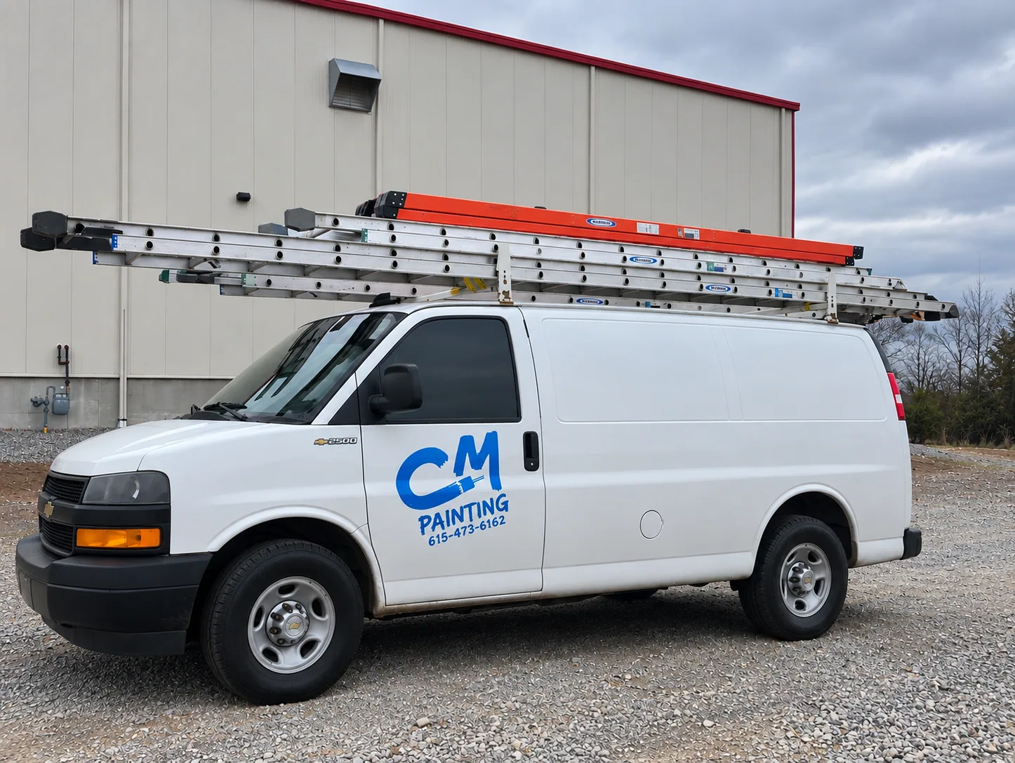 C & M Painting service van with ladders at a commercial property