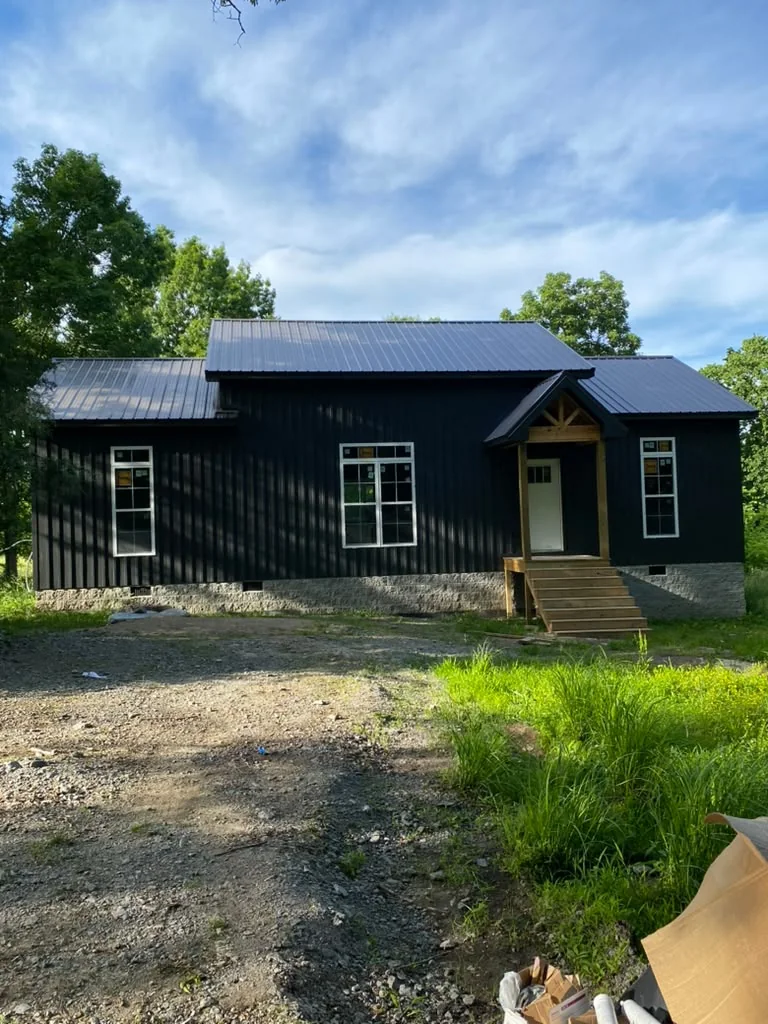 Completed cabin exterior with a dark finish and white trim