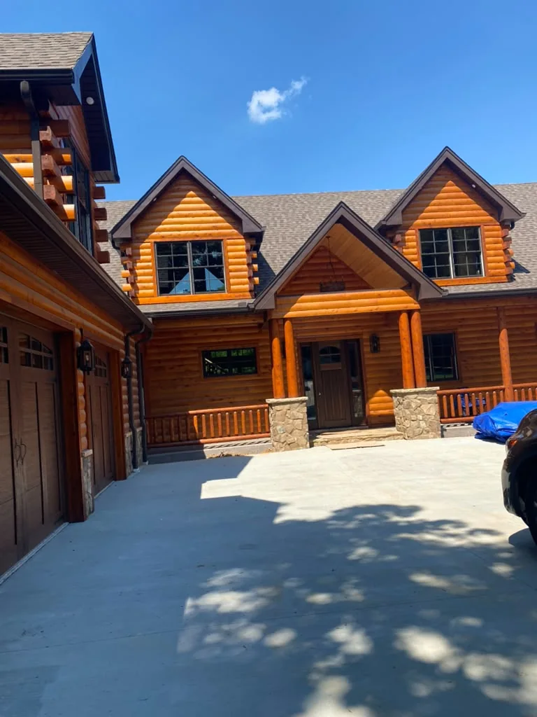 Finished stained log home entry and railing