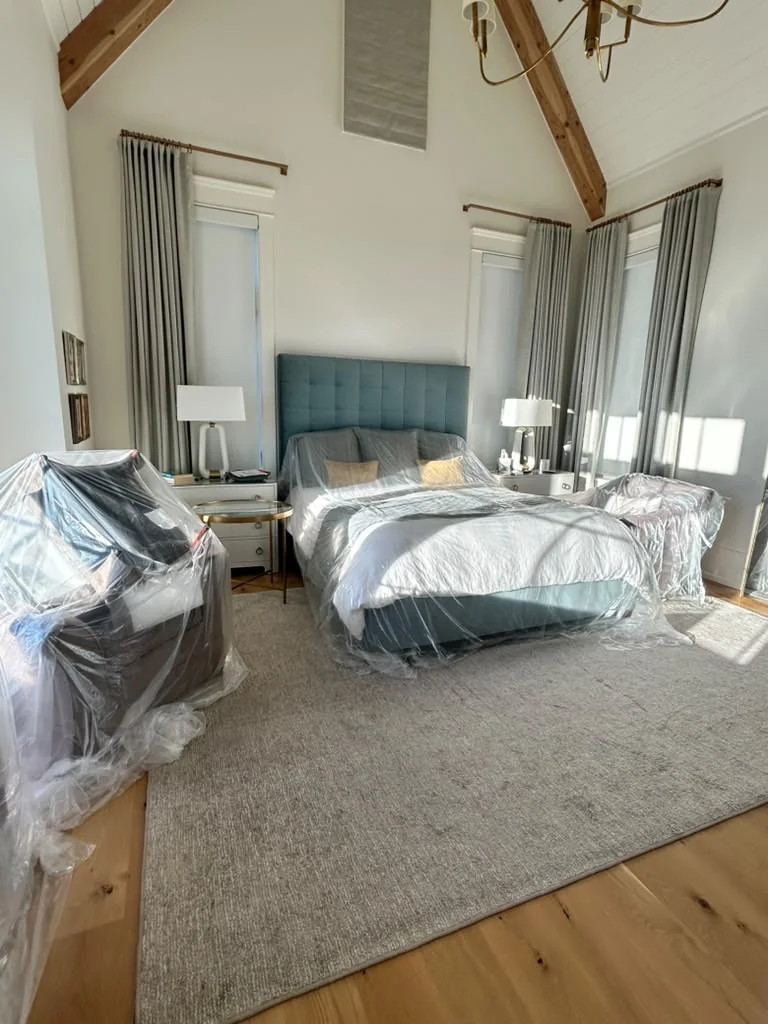 Furnished bedroom with furniture protected during interior painting